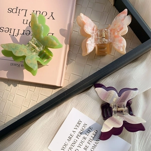 Elegant acetate butterfly hair clips in green, orange marble, and white pearl colors