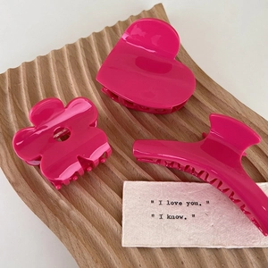Three-piece rose pink acetate hair claw clip set with flower and heart shapes