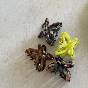 Set of four butterfly-shaped acetate hair claws in tortoise shell and neon green colors