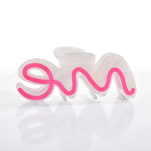 Close-up of pearl white acetate hair claw clip with pink wave pattern and spring detail