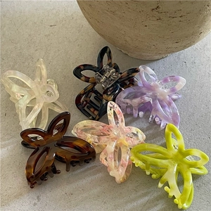 Set of six acetate butterfly hair claws in assorted pastel marble colors and floral patterns