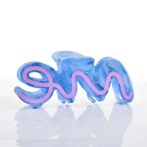 Detail shot of a large blue marble acetate claw clip with pink pattern and metal spring