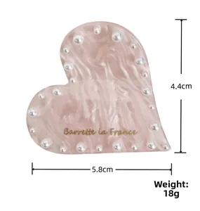 Dettaglio della pinza per capelli a cuore rosa marmorizzato con perline e misure