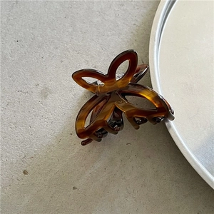 Detail of tortoiseshell acetate butterfly hair claw clip with a hollowed-out vintage design