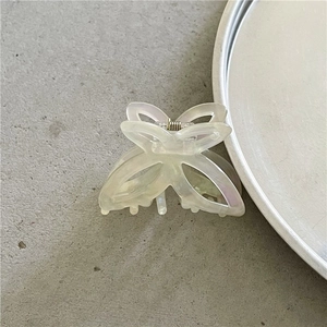 Close-up of pearlescent acetate butterfly hair claw with durable metal spring detail