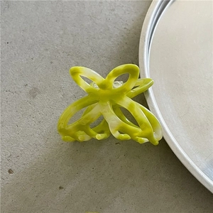 Detailed top view of the neon green and white marble acetate hair claw clip