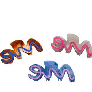 Three-piece set of wave-shaped acetate hair claws in tortoise shell, pearl white and blue