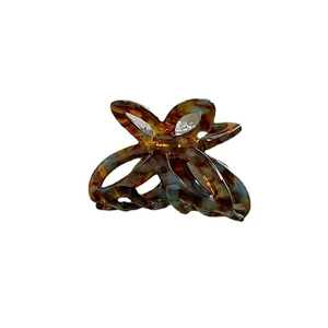Elegant tortoiseshell acetate hair claw clip with cutout floral petal design in blue and brown