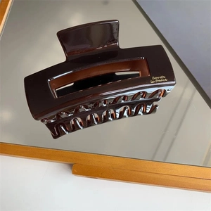 Large dark brown tortoise shell hair claw clip made of glossy acetate material
