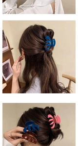Detailed view of colorful acetate hair claws in blue, pink, and brown for hair styling