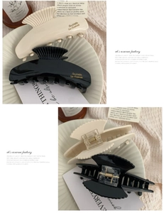 Macro detail of French style acetate shell hair claw clips with gold lettering on the side