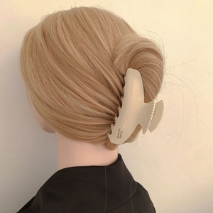 Large cream acetate scallop hair claw clip with France gold label on a model hair style