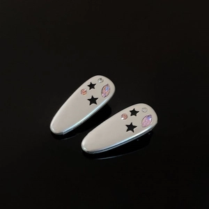 Star pattern alloy hair clips with purple zircon stones on black background