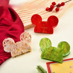 Chic Mickey-shaped acetate hair claws in festive red, green, and cream marble textures