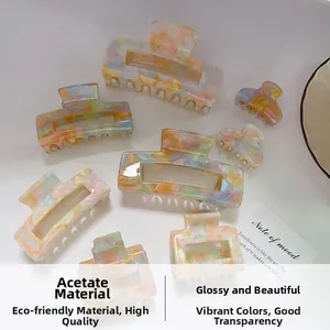 Detailed view of colorful acetate hair claws with premium rainbow marble texture