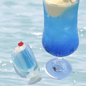 Detailed view of the blue cream soda hair claw clip with cherry and whipped cream decor