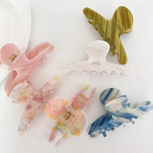 Elegant acetate hair claw clips in various marble colors and solid pastel tones