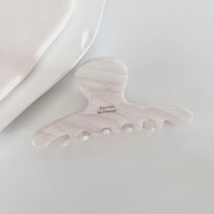 Detailed macro view of the cream marble texture on this premium acetate hair claw clip