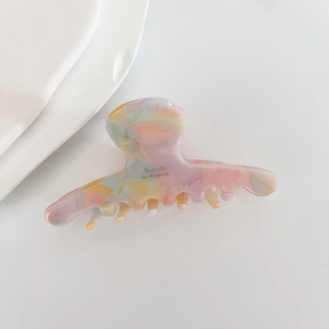 Detail of colorful marble acetate hair claw with golden Barrette La France lettering
