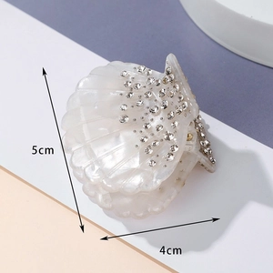 Shell-shaped pearl white acrylic hair claw with sparkling rhinestones size 5cm x 4cm