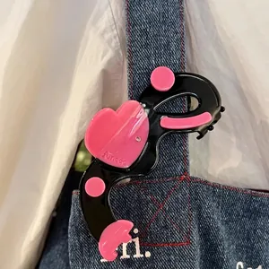 Pince à cheveux élégante en forme de cœur en acétate avec strass en contraste noir et rose