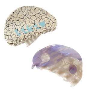 Semicircle acetate hair claw set featuring purple marble swirl and cream letter pattern