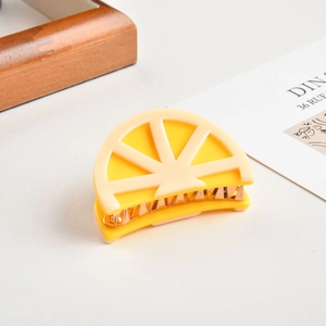 Cute lemon slice shaped acetate hair claw clip with yellow and white fruit patterns