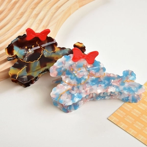 Detail view of retro acetate dog hair claws with tortoiseshell and marble patterns