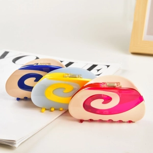 Detailed view of resin hair claws featuring vibrant macaron color spiral patterns and metal spring