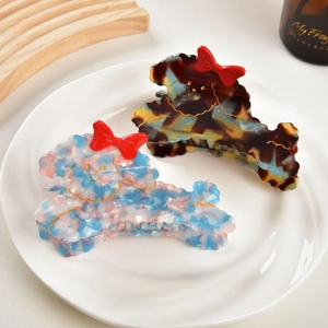 Cute poodle dog shaped acetate hair claw clips with red bows in swirl blue and brown marble