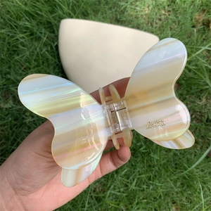 Detail of butterfly hair claw clip with pearlescent acetate and Barrette La France engraving