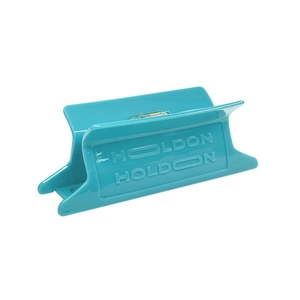 Detail of teal acetate hair claw clip featuring polished finish and silver spring
