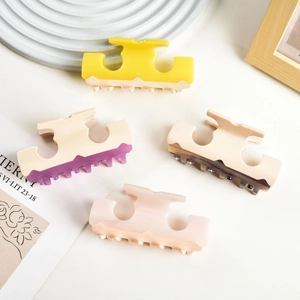 Elegant wavy cream and pastel acetate hair claws set of four shown in lifestyle setting