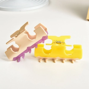 T-shaped acetate hair claw clip in cream and purple with liquid drip design effect