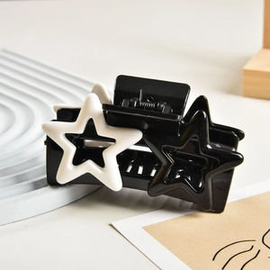 Close-up of Y2K star hair claw clip with black and white hollow star patterns