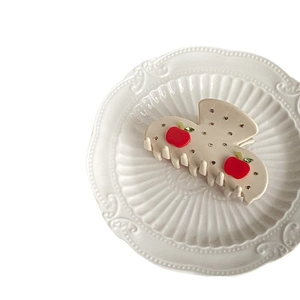 Elegant cream acetate hair claw clip featuring 3D red apple design and sparkling rhinestones