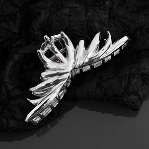 Irregular large silver metal shark hair claw clip with liquid metal design on black fabric