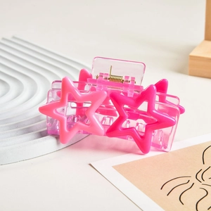 Detailed view of pink Y2K star hair claw clip with acrylic finish and gold metal spring