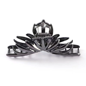 Detail of gunmetal irregular metallic claw clip showing tiered petal design and sturdy spring