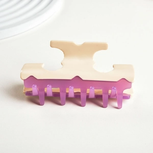 Detail of cream and translucent purple acetate hair claw clip with sturdy spring and teeth