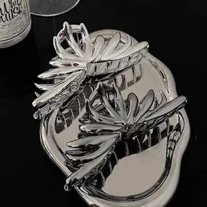 Silver irregular metal hair claw set with mirror finish and abstract butterfly design