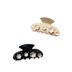 Elegant flower petal hair claw clips set in beige and black with rhinestone details