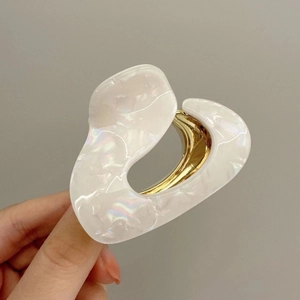 Minimalist heart-shaped acetate hair claw clip with iridescent white marble finish
