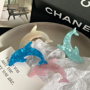 Cute dolphin-shaped hair clips in acrylic with marble texture in four assorted colors