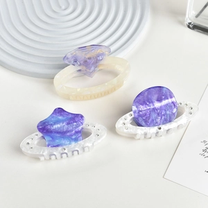 Elegant planet-themed acetate hair claws set with rhinestones and purple nebula patterns