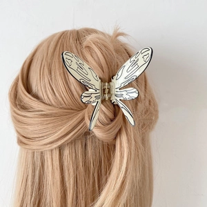 Elegant butterfly hair claw clip with black vein patterns on cream acetate finish