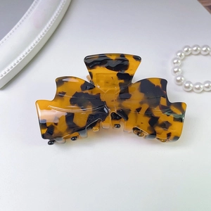 Close-up of tortoiseshell acetate hair claw clip with stylish leopard print texture