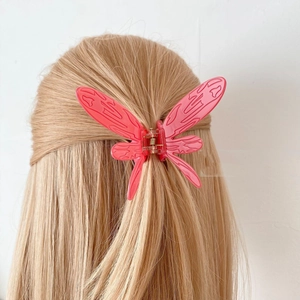 Pink butterfly hair claw clip for women made of translucent resin with intricate wing texture