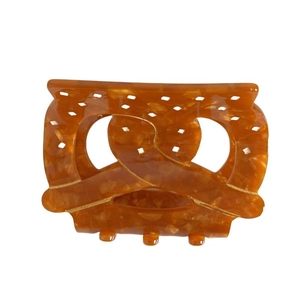 Elegant amber acetate pretzel hair claw clip with marble texture and golden line details