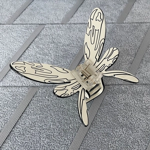 Detailed macro view of butterfly hair claw clip with cream base and black abstract lines